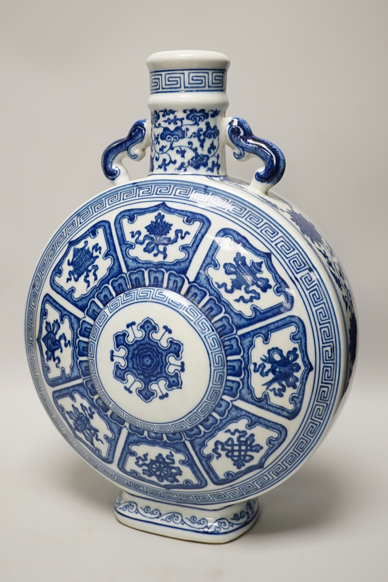 A Chinese blue and white two handled moonflask, together with another Chinese vase and Chinese figure group, tallest 36cm